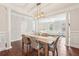 Well-lit dining area featuring hardwood floors, modern lighting, and an open view to the living room at 3694 Lambert Ne Ln, Atlanta, GA 30319