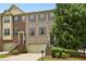 Brick townhome featuring attached garages, well maintained landscaping, and a welcoming entrance at 3694 Lambert Ne Ln, Atlanta, GA 30319