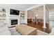 Open-concept living room showcasing a fireplace, built-in shelving, and hardwood floors at 3694 Lambert Ne Ln, Atlanta, GA 30319