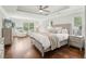 Spacious main bedroom with a tray ceiling, large windows, and hardwood floors at 3694 Lambert Ne Ln, Atlanta, GA 30319