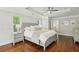 Bright main bedroom with a tray ceiling, wooden floors, and large windows at 3694 Lambert Ne Ln, Atlanta, GA 30319