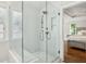 Shower featuring white tile with brass fixtures and a seamless glass door at 3694 Lambert Ne Ln, Atlanta, GA 30319