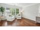 Comfortable sitting area in the main bedroom with natural light and hardwood floors at 3694 Lambert Ne Ln, Atlanta, GA 30319