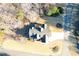 Aerial view of a house with a large driveway and a landscaped yard nestled in a serene, wooded neighborhood at 103 Old Avery Dr, Canton, GA 30115