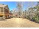 Spacious backyard showing manicured shrubs and wooded areas, offering privacy at 103 Old Avery Dr, Canton, GA 30115