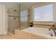 Beautiful bathroom with glass shower, soaking tub, and decorative tile surround at 103 Old Avery Dr, Canton, GA 30115