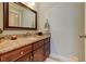Elegant bathroom with granite countertop, dark wood cabinets, and a framed mirror, offering a luxurious feel at 103 Old Avery Dr, Canton, GA 30115