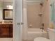 Bathroom features a wood vanity with granite countertops, bathtub with shower, and modern fixtures at 103 Old Avery Dr, Canton, GA 30115
