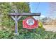 A rustic, wooden sign identifying the entrance to the 'Old Avery Parc' neighborhood surrounded by lush greenery at 103 Old Avery Dr, Canton, GA 30115
