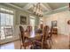 Dining room with a large wooden table set with chairs, natural light, and vintage hutch at 103 Old Avery Dr, Canton, GA 30115