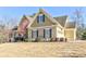 Stylish two-story home featuring a gable roof, meticulously landscaped yard, and classic architectural design at 103 Old Avery Dr, Canton, GA 30115