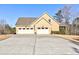 Spacious three-car garage featuring a long driveway, meticulously landscaped yard, and classic architectural design at 103 Old Avery Dr, Canton, GA 30115