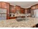 Close-up of a kitchen island with stainless steel sink and granite countertops at 103 Old Avery Dr, Canton, GA 30115