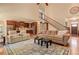 Open-concept living room with hardwood floors, staircase, and seamless flow to the kitchen at 103 Old Avery Dr, Canton, GA 30115