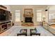 Inviting living area showcasing a stone fireplace, TV, and area rug over hardwood flooring at 103 Old Avery Dr, Canton, GA 30115