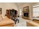 Living room with stone fireplace, entertainment center, hardwood floors, and natural light at 103 Old Avery Dr, Canton, GA 30115