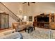 Inviting living room with hardwood floors, comfortable seating, and elegant staircase at 103 Old Avery Dr, Canton, GA 30115