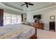 Main bedroom with tray ceiling, fan, dresser, and cozy seating area near windows at 103 Old Avery Dr, Canton, GA 30115