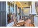 Charming porch with rocking chairs, stone columns, and decorative accents, creating an inviting outdoor living space at 103 Old Avery Dr, Canton, GA 30115