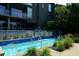 Outdoor pool featuring deck jets, greenery, and an adjacent building at 195 Arizona Ave # 179, Atlanta, GA 30307