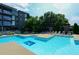 Outdoor pool with lounge chairs, tables, and an adjacent building at 195 Arizona Ave # 179, Atlanta, GA 30307