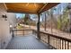 Spacious covered back porch featuring a wood railing and scenic views at 541 Glen Abbey Se Cir, Mableton, GA 30126