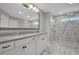 Bathroom with a double sink vanity, grey countertops, modern fixtures, and glass enclosed shower at 541 Glen Abbey Se Cir, Mableton, GA 30126