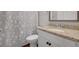 Bathroom with a granite countertop, white vanity, and a shower with floral curtain at 541 Glen Abbey Se Cir, Mableton, GA 30126
