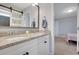Bathroom featuring double vanity, granite countertops, modern fixtures, and decorative mirror at 541 Glen Abbey Se Cir, Mableton, GA 30126