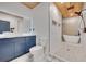 Modern bathroom with double shower head, soaking tub, blue vanity, and luxury finishes at 541 Glen Abbey Se Cir, Mableton, GA 30126