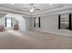 Spacious bonus room with vaulted ceiling, ceiling fan, neutral carpet, and natural light at 541 Glen Abbey Se Cir, Mableton, GA 30126
