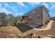 Exterior view of the home showcasing the deck, patio, landscaped backyard, and multi-level design at 541 Glen Abbey Se Cir, Mableton, GA 30126