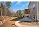 Exterior view of the house with an upper level deck, a lower patio, landscaped yard, and natural surroundings at 541 Glen Abbey Se Cir, Mableton, GA 30126