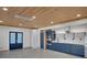 Modern kitchen features blue cabinets, stainless steel appliances, and stylish wood ceiling at 541 Glen Abbey Se Cir, Mableton, GA 30126