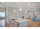 Open concept kitchen with a center island featuring a stainless steel sink and modern faucet at 541 Glen Abbey Se Cir, Mableton, GA 30126