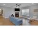 Spacious living room featuring hardwood floors, a fireplace, and a ceiling fan at 541 Glen Abbey Se Cir, Mableton, GA 30126
