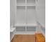 Mudroom with a wooden bench, open storage cabinets, and a whiteboard at 541 Glen Abbey Se Cir, Mableton, GA 30126