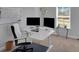 Office space with a white desk, dual monitors, and natural light, ideal for productivity at 541 Glen Abbey Se Cir, Mableton, GA 30126