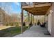 Covered patio features concrete flooring, wooden beams, fenced yard and seating area, perfect for outdoor enjoyment at 541 Glen Abbey Se Cir, Mableton, GA 30126