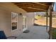 Covered patio area with concrete flooring, access door, and a cozy outdoor space for relaxation and entertainment at 541 Glen Abbey Se Cir, Mableton, GA 30126