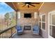 Covered porch features a stone fireplace and comfortable seating area at 541 Glen Abbey Se Cir, Mableton, GA 30126