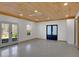 Large room with light concrete floors, wood ceilings, and doors to the outside at 541 Glen Abbey Se Cir, Mableton, GA 30126