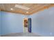 Bedroom showcasing wood ceiling, gray concrete floor, and open door to kitchen at 541 Glen Abbey Se Cir, Mableton, GA 30126