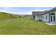 Expansive backyard featuring lush green grass and a gentle slope, perfect for outdoor activities and enjoying nature at 64 Lakeview Pt, Dallas, GA 30157