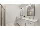 Bright bathroom featuring a shower, double sink vanity with white countertops, and modern fixtures at 64 Lakeview Pt, Dallas, GA 30157