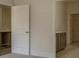 Neutral bedroom with ensuite bathroom featuring modern finishes and adjacent walk-in closet with door at 64 Lakeview Pt, Dallas, GA 30157
