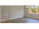Dining room with hardwood floors, chandelier, white trim, and large window providing wooded backyard view at 64 Lakeview Pt, Dallas, GA 30157