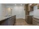 Kitchen island features granite counters, a stainless steel sink, modern faucet, and hardwood style floors at 64 Lakeview Pt, Dallas, GA 30157