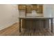 Island kitchen with granite countertops, wood cabinets, and open layout great for entertaining at 64 Lakeview Pt, Dallas, GA 30157
