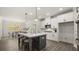 Spacious kitchen featuring an island with barstool seating, stainless steel appliances, and elegant lighting fixtures at 64 Lakeview Pt, Dallas, GA 30157